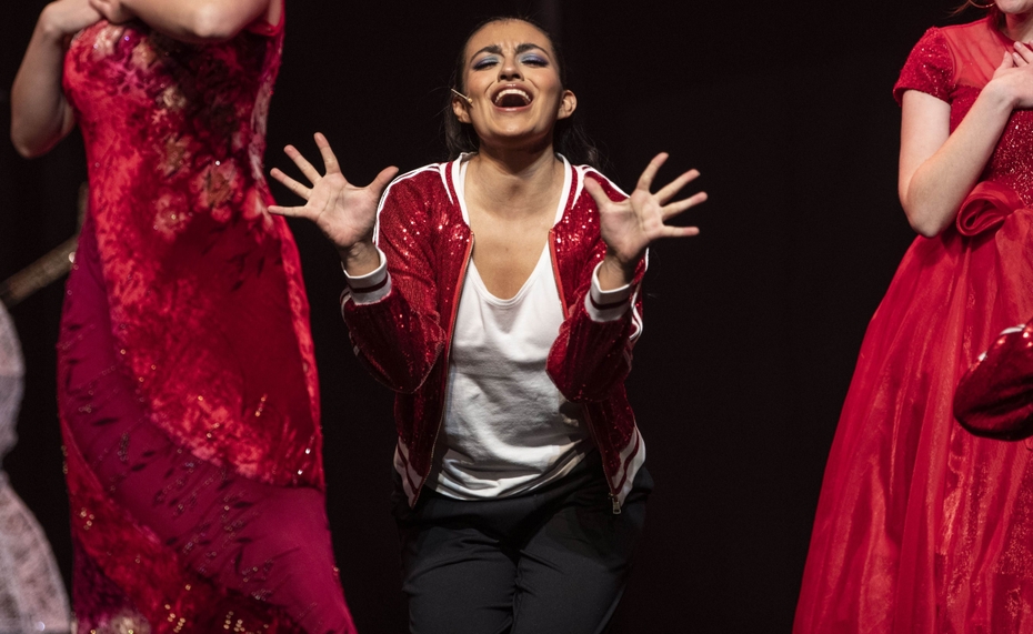A music theatre student performs on stage